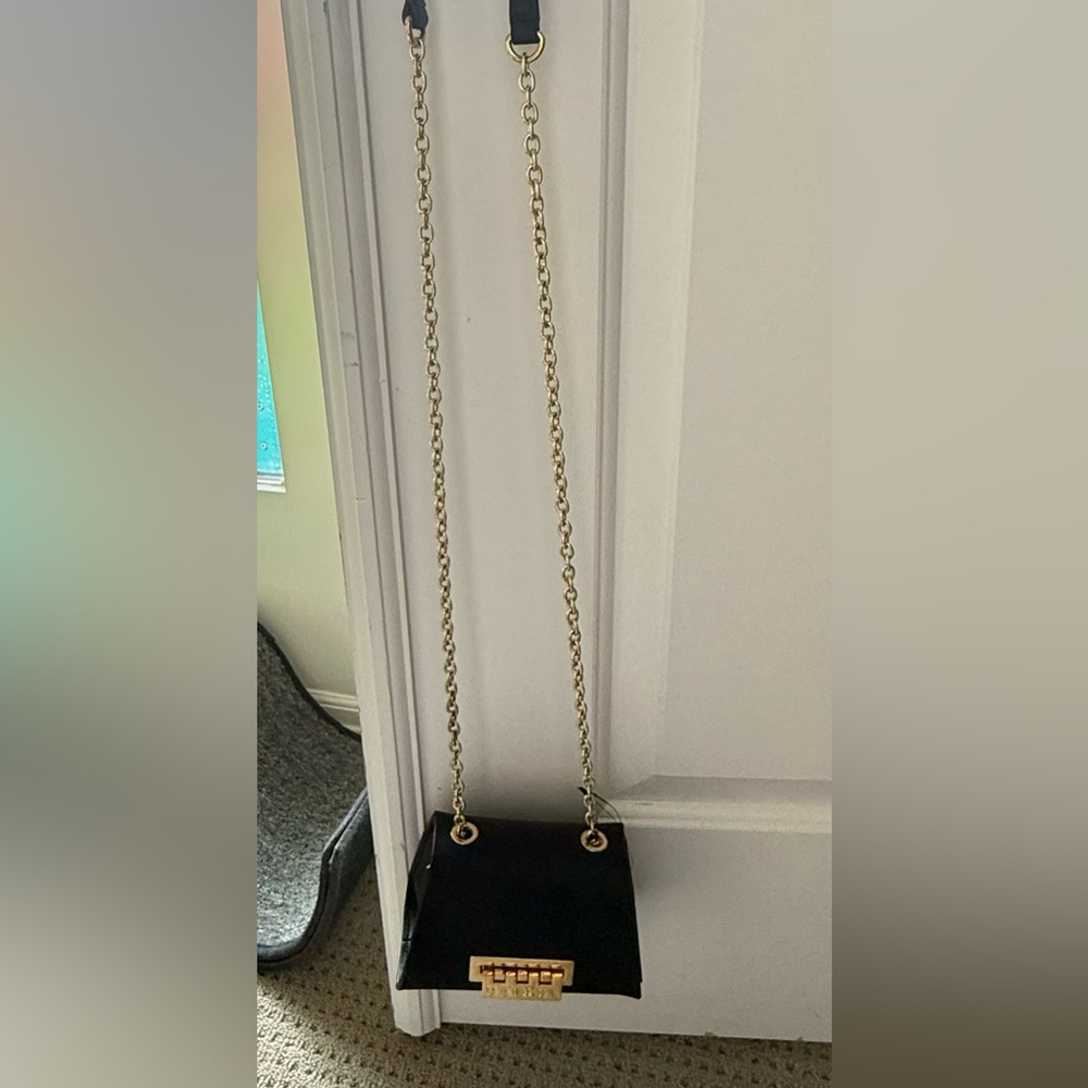 Zac Posen Black evening purse. Gold accessories.
Never Worn. NWT.